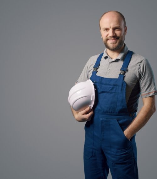 Confident,Repairman,Posing,And,Holding,A,Safety,Helmet